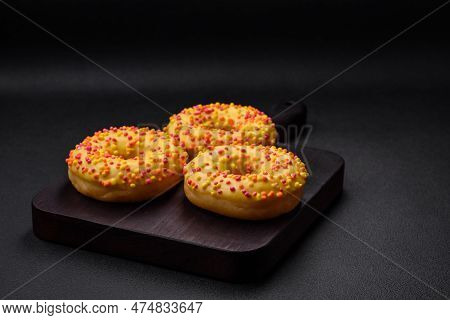 Delicious Fresh Donuts In Yellow Glaze With Lemon Flavor Filling