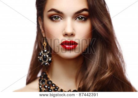 Beauty Model Woman with Long Brown Wavy Hair. Healthy Hair and Beautiful Professional Makeup.