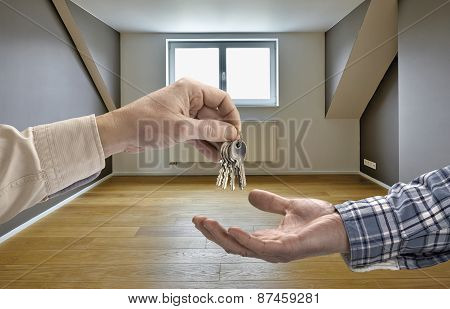 Realtor Giving House Key To Buyer In Empty Room