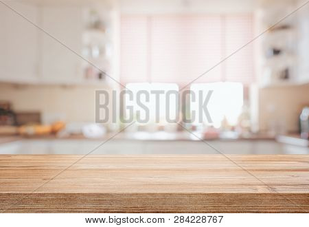 Empty Tabletop Over Defocused Kitchen With Copy Space