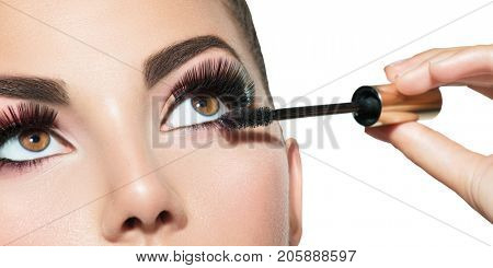 Mascara Applying. Long Lashes closeup. Mascara Brush. Eyelashes extensions. Makeup for Brown Eyes. Eye Make up Apply, Eyebrows shaping. Beautiful woman eyes make-up