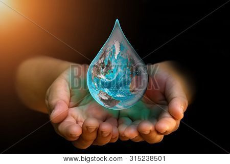 Blue Earth World With Dripping Water On Two Hand At Wait On Abstract Black Background. Water Shortag