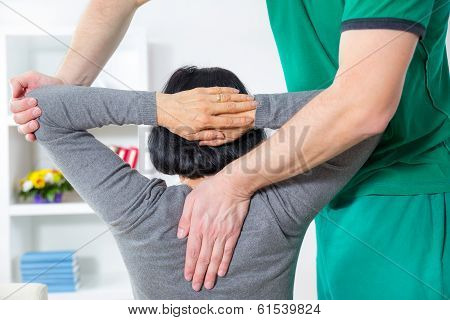 Chiropractor massage the female patient spine and back