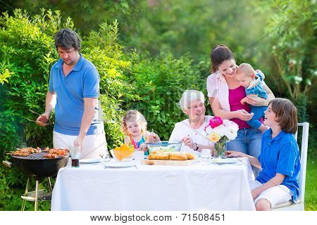 Big Family Grilling Meat For Lunch