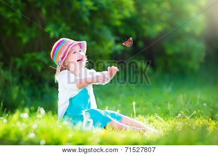 Toddler Girl Playing With Butterfly