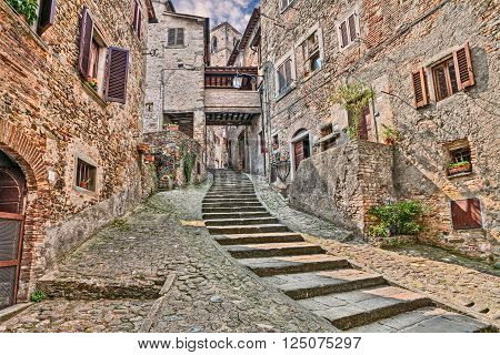 picturesque old narrow alley with staircase in the medieval village Anghiari, province of Arezzo, Tuscany, Italy