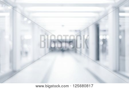 abstract defocused blurred background empty business corridor or shopping mall. Medical and hospital corridor defocused background with modern laboratory (clinic)