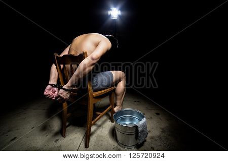 Prisoner being punished with cruel interrogation technique of waterboarding