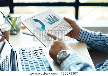 Business adviser analyzing financial figures denoting the progress in the work of the company