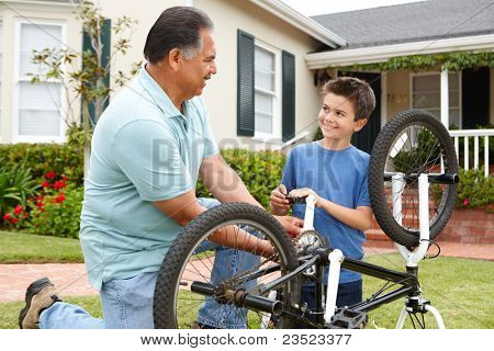 boy and grandfather fixing bike