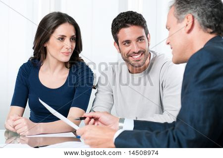 Financial consultant presents bank investments to a young couple