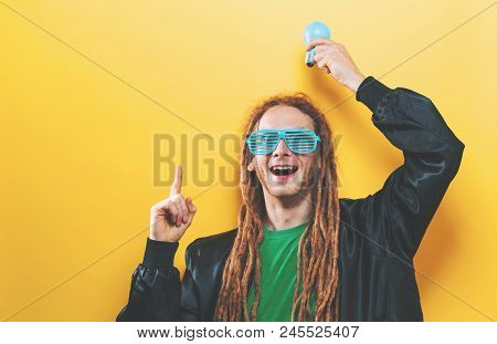 Funky Fashion Man With Quirky Lightbulbs On A Yellow Background