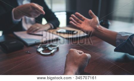 Police Officer Interrogating Suspect Or Criminal Man With Handcuffs Arrested At The Investigation