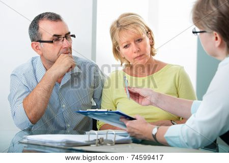 Mature couple getting financial advice from consultant at home