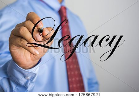 Businessman Writing Legacy Word On Virtual Screen