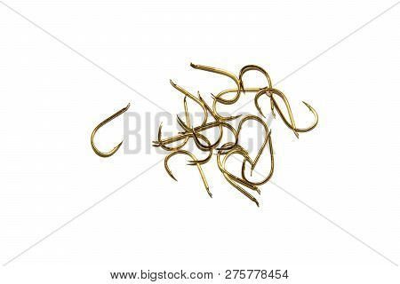 Fishing Hooks In Gold Color. Different Patterns Of Metal Fishing Hooks. Abstraction. Isolated.