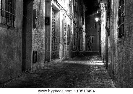 A Narrow European Street at Night in Black and White