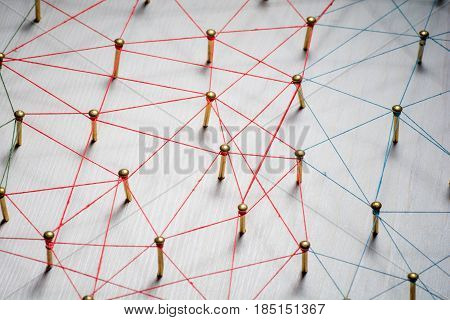 Linking entities. Network, networking, social media, internet communication abstract. A small connected to larger . Web of gold wires on rustic wood.