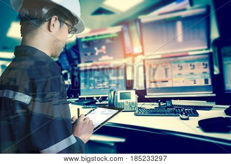 Double exposure of Engineer or Technician man in working shirt working with tablet in control room of oil and gas platform or plant industrial for monitor process business and industry concept