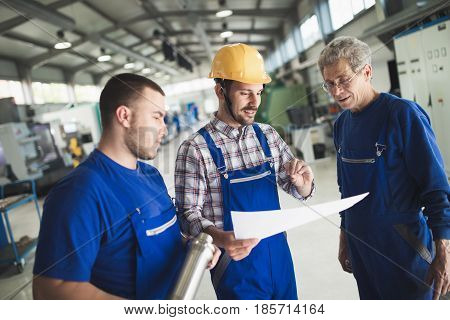 Mechanical and metal industry engineers working in factory