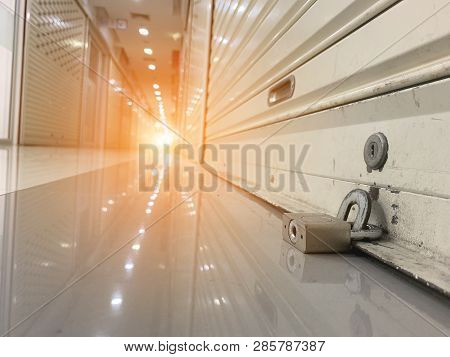 Warehouse Of Retail Merchandise Shop Combination Lock On A Self Storage Door With White Storage Unit