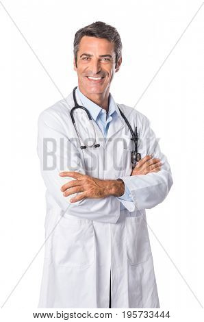 Portrait of smiling mature doctor isolated on white background. Happy senior doctor looking at camera and wearing white lab coat. Friendly male doctor posing with crossed arms.