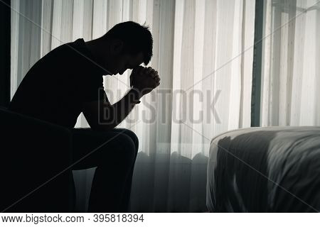 Silhouette Depressed Man Sadly Sitting On The Bed In The Bedroom, Depression Concept