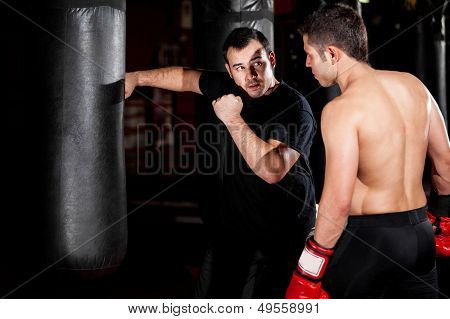 Boxer and coach training at a gym