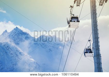 Cable Car On The Ski Resort And Snow-covered Mountains