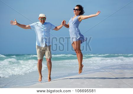 Young couple having fun at tropical beach, Siesta Key, Florida