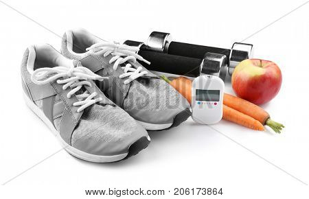 Composition with digital glucometer and sport inventory on white background. Diabetes concept