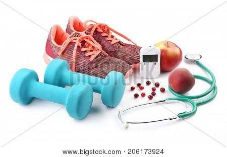 Composition with digital glucometer, stethoscope and sport inventory on white background. Diabetes concept