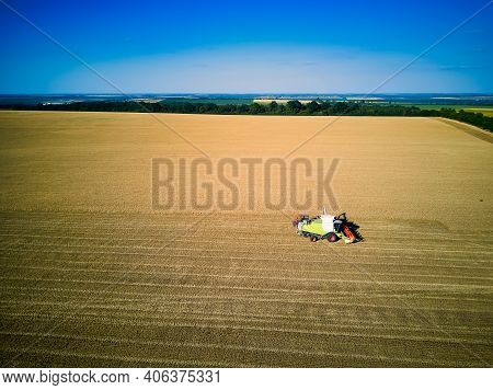 Aerial View On Combine Harvester Gathers The Wheat At Sunset. Harvesting Grain Field, Crop Season. V