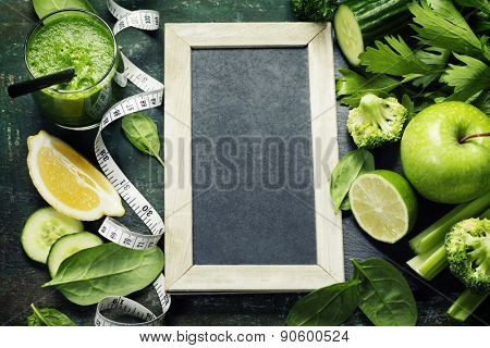 Fresh green vegetables and smoothie on vintage background - detox, diet or healthy food concept