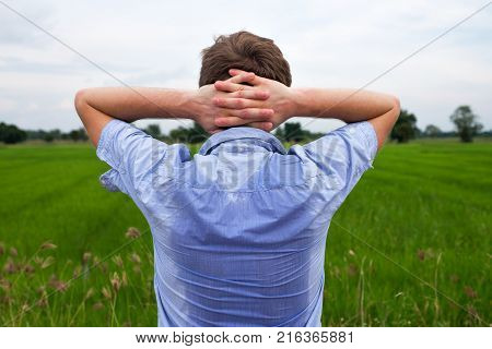 Man with hyperhidrosis sweating very badly under armpit in blue shirt because of hot weather. Travelling in asia thailand with backpacker