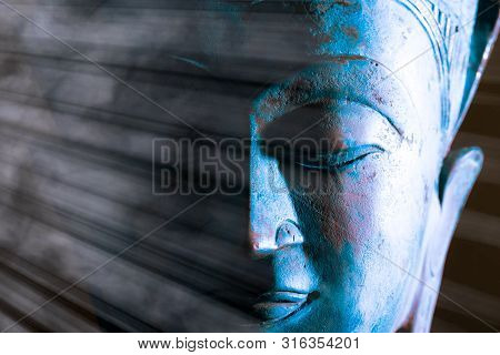 Buddha Face Close-up. Spiritual Enlightenment. Zen Buddhism. Traditional Thai Statue With Ethereal L