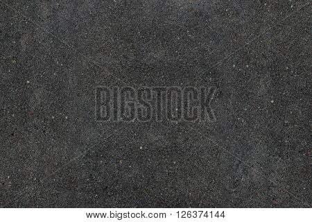 Real asphalt texture background. Coloured dark black asphalt pattern. Grainy street detail gray textured background. Best way show your design or illustration with this actual asphault photo texture.