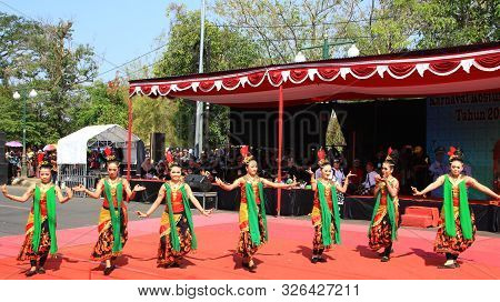 A Group Of Dancers While Performing On The Street Stage, Dancing To Traditional Javanese Dance, Peka