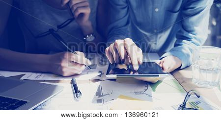 Photo Woman Hand Touching Digital Tablet Screen.Analyst Department Researching Process.Young Business Crew Working New Startup modern Studio.Analyze markets stocks.Blurred, film effect.Wide