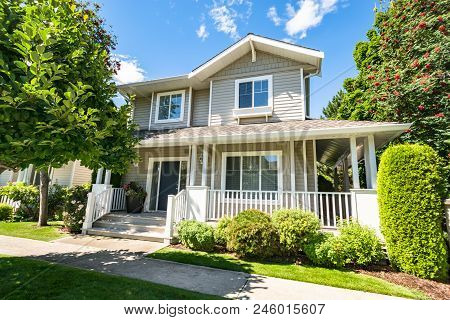 Perfect Neighbourhood. Main Entrance Of Residential House With Concrete Pathway Over The Front Yard 