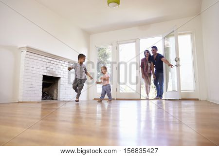 Excited Family Explore New Home On Moving Day