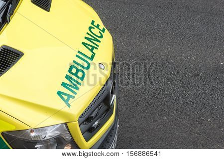 WREXHAM UK - AUGUST 30 2016: Bonnet of an emergency service ambulance on a street in Wales. Elevated point of view with copy space.