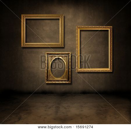 A dark, grungy room with gold frames on the wall