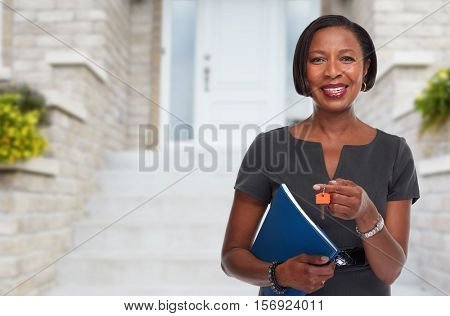 African-American realtor woman with key.