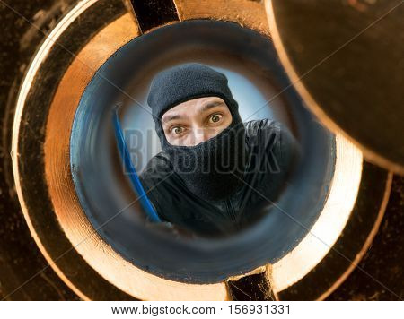 View Through Pipehole. Robber Or Burglar Masked With Balaclava B