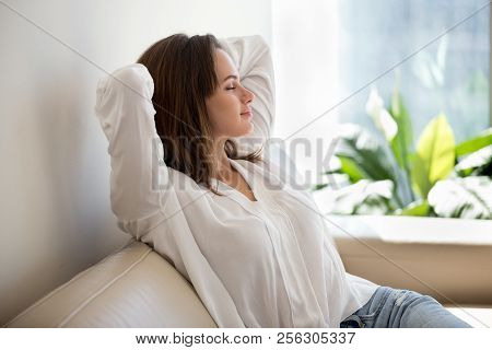 Relaxed Woman Resting Breathing Fresh Air At Home On Sofa