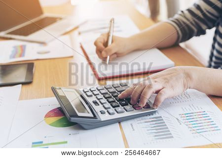 Close Up Hand Of Business Employee Accountant With Calculator Calculating Annual Income Tax And Comp