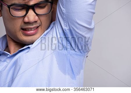 Close Up Asian Man With Hyperhidrosis Sweating. Young Asia Man With Sweat Stain On His Clothes Again