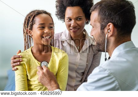 Doctor Examines A Child With Stethoscope In Examination Room. Healthcare People Children Concept