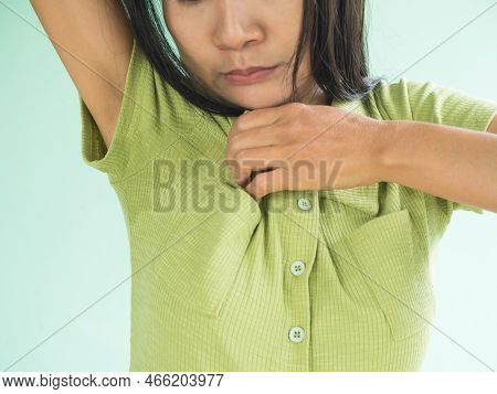 Woman Hyperhidrosis Wet Green Shirt Underarm Hand Close Up. Problem Armpit Sweat Stains And Strong B